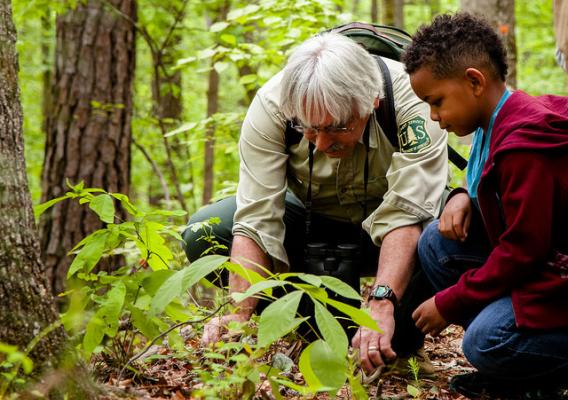 Dennis Krusac teaching a young neighbor about plants