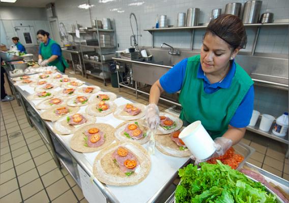 A school food professional preparing school meals