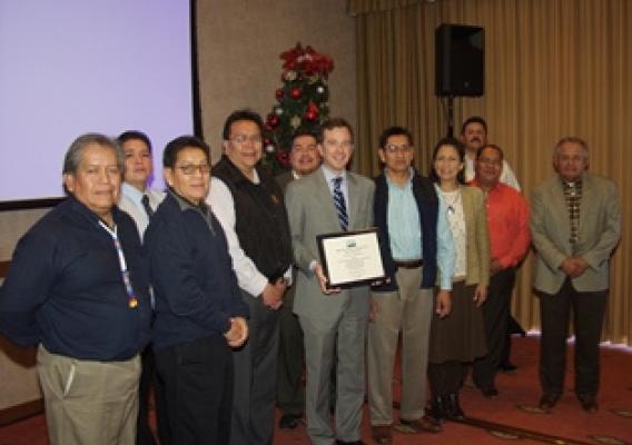   USDA Rural Development New Mexico State Director Terry Brunner (center) presents a certificate of obligation to the Ten Southern Pueblo Council Governors and representatives during ceremonies to celebrate the successful application of funds creating the first ever Native American Food Hub in the nation. (USDA Photo)