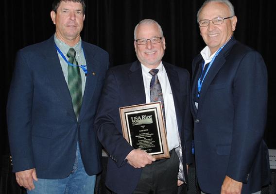 Former NRCS Chief Dave White holding his award from USA Rice Federation, flanked by California rice producers Leo LaGrande (left) and Al Montna (right). Photo: USA Rice Daily (used with permission)