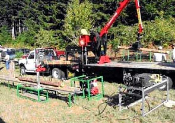 The vehicle pictured is a portable roundwood processor.