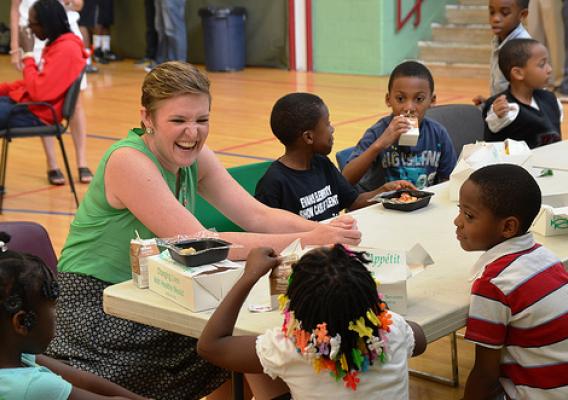 The Director of USDA’s Center for Faith-Based and Neighborhood Partnerships, Norah Deluhery, eats lunch with kids at a Philadelphia Archdiocese’s Nutritional Development Services (NDS) summer food service site.  The Center maintains integral relationships with partners like NDS to ensure disadvantaged children don’t go hungry when school is out.