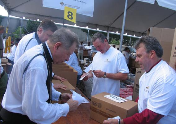 SWR RA Ludwig, Archbishop Gregory Michael Aymond, Priest Larry Snyder, and Roy Zuppardo, Chair of Second Harvest Food Bank Greater New Orleans and Acadiana assembled emergency food boxes at the food bank.