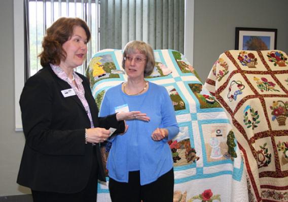 Administrator Canales talks with Martha Perkins, local Bath County Family Consumer Science Agent during a tour of the new marketing center.