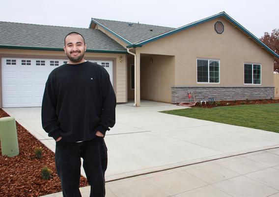 Robert Tapia, a single father of two, is pictured outside the Reedley, Calif. home he proudly helped build with ten other families through USDA's Mutual Self-Help Housing Loan program in partnership with Self-Help Enterprises, which celebrated the completion of its 6,000th home last week. (USDA photo)