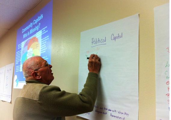 Wall, South Dakota Mayor Dave Hahn adds his name under one of the community capitals as his region builds their planning team for regional economic development through USDA Rural Development.