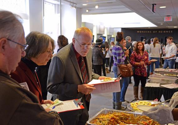 Dr. Robert Post, Deputy Director, CNPP, judges meals prepared by culinary students from DC Central Kitchen at the Koshland Science Museum’s Healthy Plate Cook-Off, on November 15, 2012.  Photo by: Chaya Pooput, Ph.D.