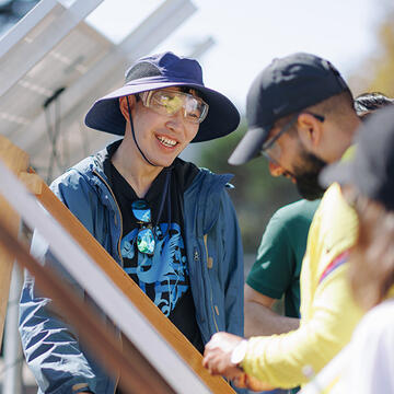 energy systems management students building solar panels outside