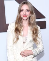 Amanda Seyfried Looking at camera Smiling wearing cream colored blazer and matching top