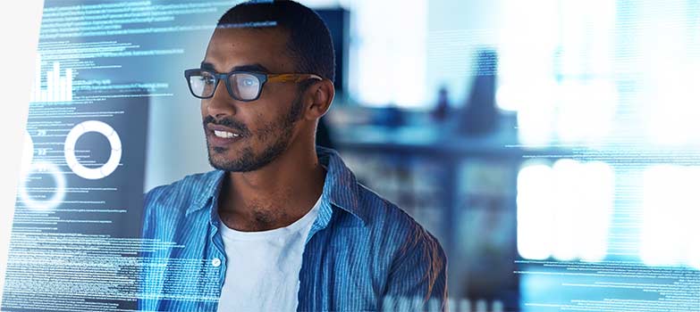 Image of a person looking at computer code on a monitor.