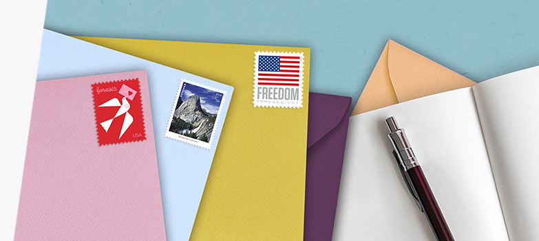 Assortment of colored envelopes with the Love, Waterfalls, and U.S. Flag First-Class Mail Forever stamps.