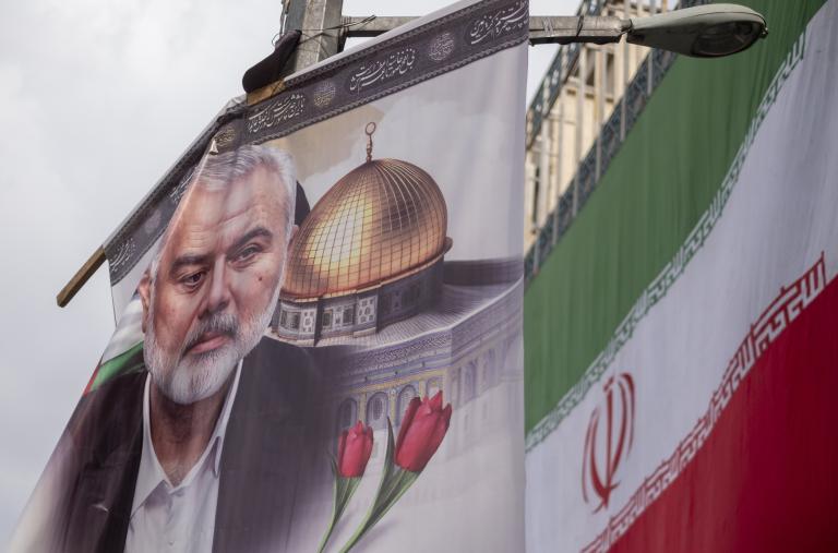 A poster depicts former Hamas leader Ismail Haniyeh alongside the Iranian flag in Tehran following Haniyeh's killing in Iran - source: Reuters