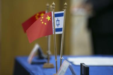 Chinese and Israeli flags on a table at a diplomatic conference - source: Reuters