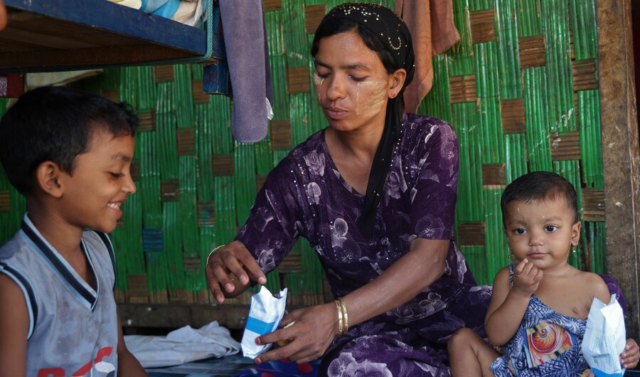 Ma Nyo Nyo's kids enjoy WFP's High Energy Biscuits. The storm that hit their home in Myanmar's Rakhine State destroyed their meagre food supplies. Photo: WFP/Su Myat Yadanar