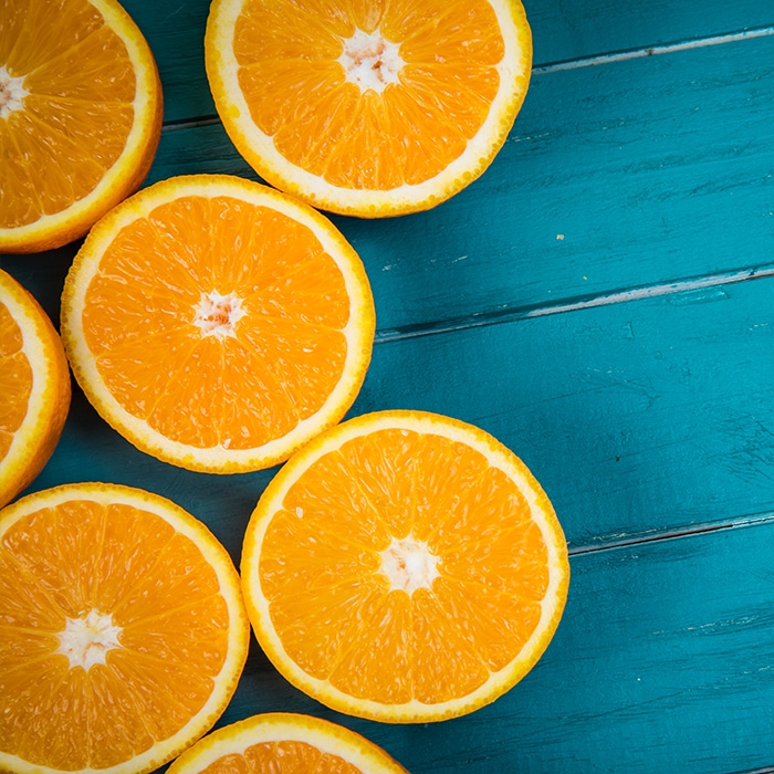 cut open oranges with blue background