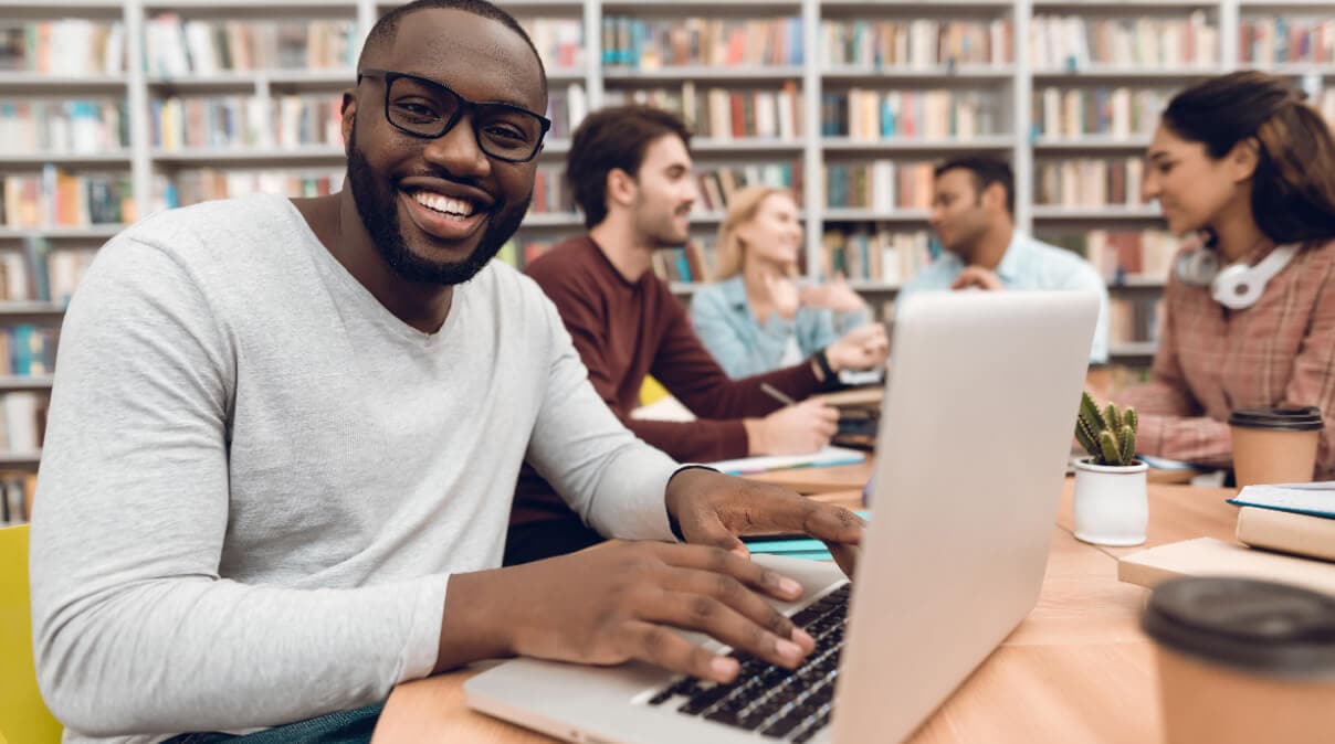 Man on laptop in library