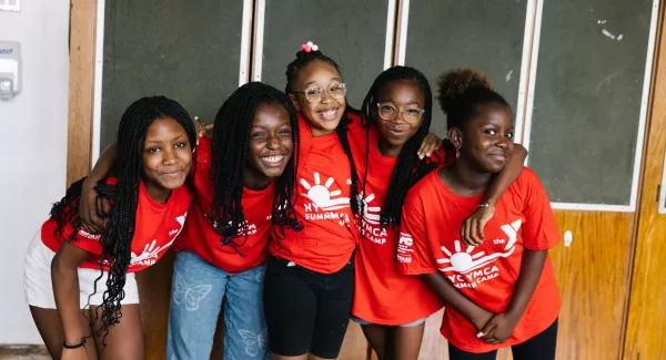 5 girls in a group smile