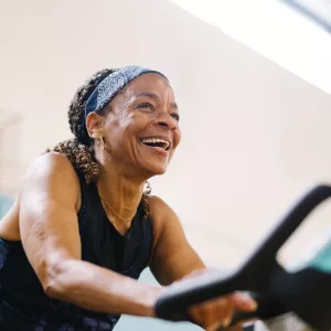 woman with bandana on spin bike