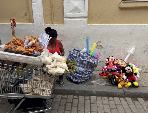 Uma mulher vende Mickeys e Minnies de pelúcia junto com guloseimas  locais em Havana Vieja (Foto: Ana Carolina Fernades)