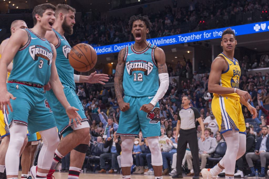 Jan 12, 2020; Memphis, Tennessee, USA; Memphis Grizzlies guard Ja Morant (12) reacts during the second half against Golden State Warriors guard Jordan Poole (3)  at FedExForum. Mandatory Credit: Justin Ford-USA TODAY Sports