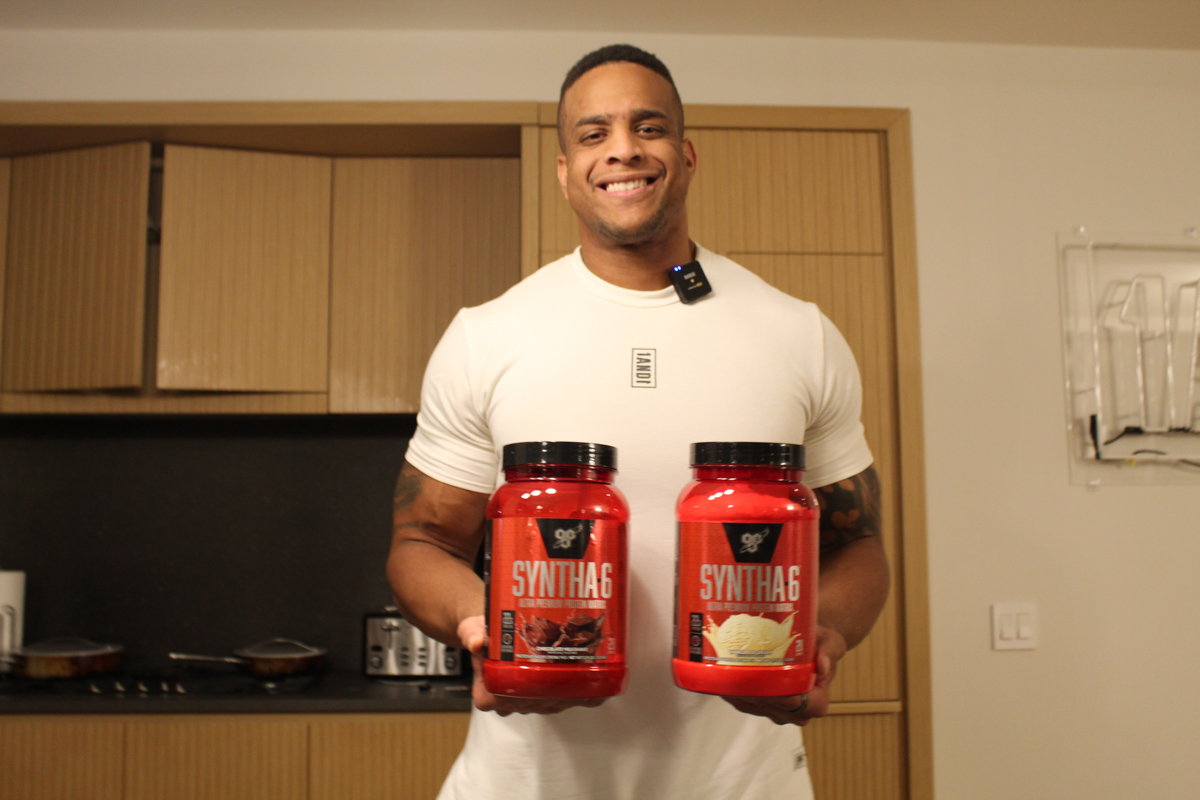 Corey Lewis holding Syntha 6 protein kitchen