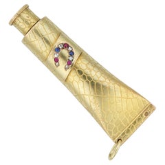 A jewelled gold trompe l’oeil scent bottle