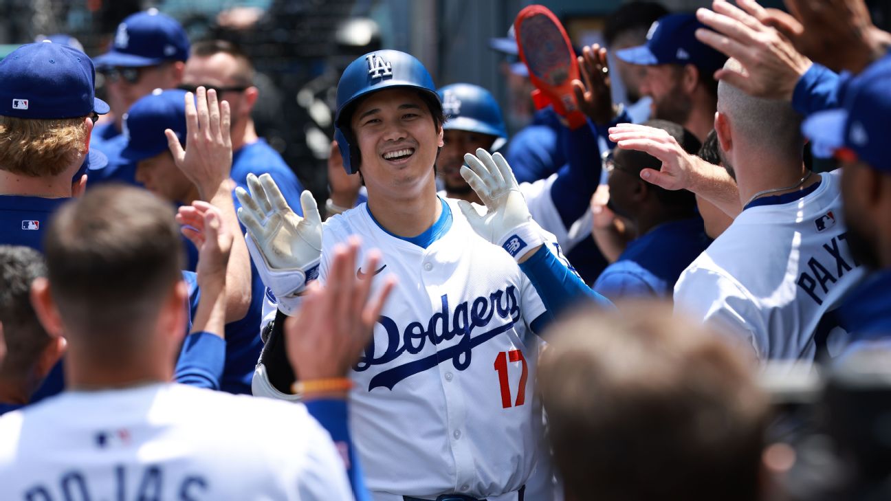 Los Angeles Dodgers designated hitter Shohei Ohtani is greeted by teammates after hitting a home run during the first inning against the Atlanta Braves at Dodger Stadium.