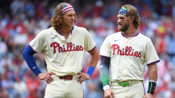 Philadelphia Phillies third baseman Alec Bohm and  first baseman Bryce Harper in between innings against the Oakland Athletics at Citizens Bank Park. 