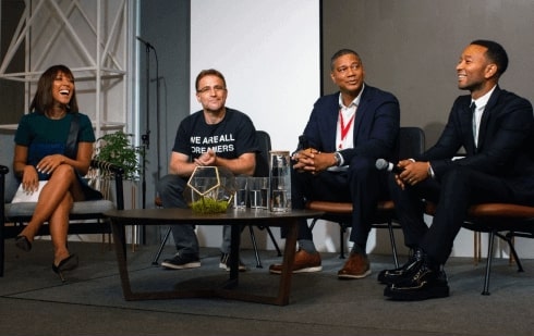 Robin Thede, Stewart Butterfield, Kenyatta Leal, and John Legend sit together on stage during a panel announcing the Next Chapter program.