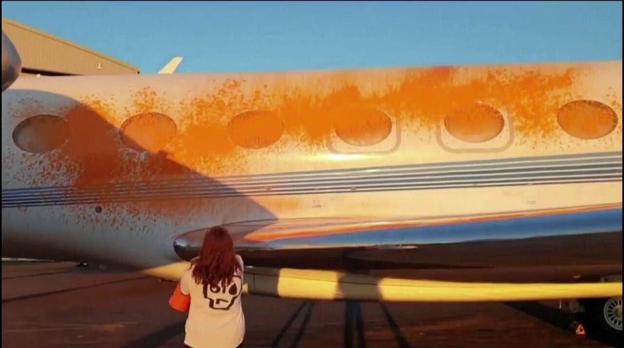 Climate activists in London spray-paint private jets orange
