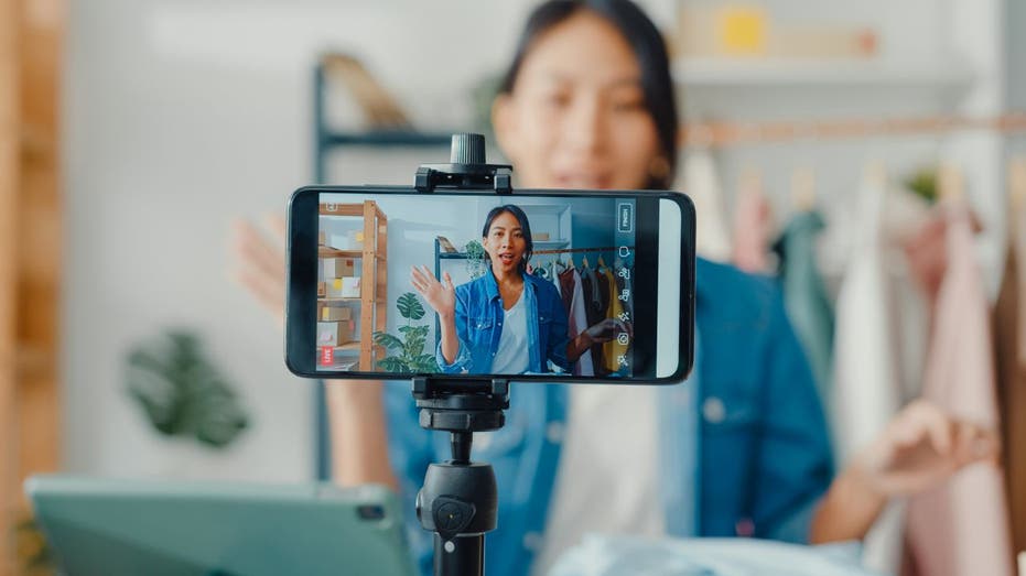 Woman talks to phone camera during remote interview