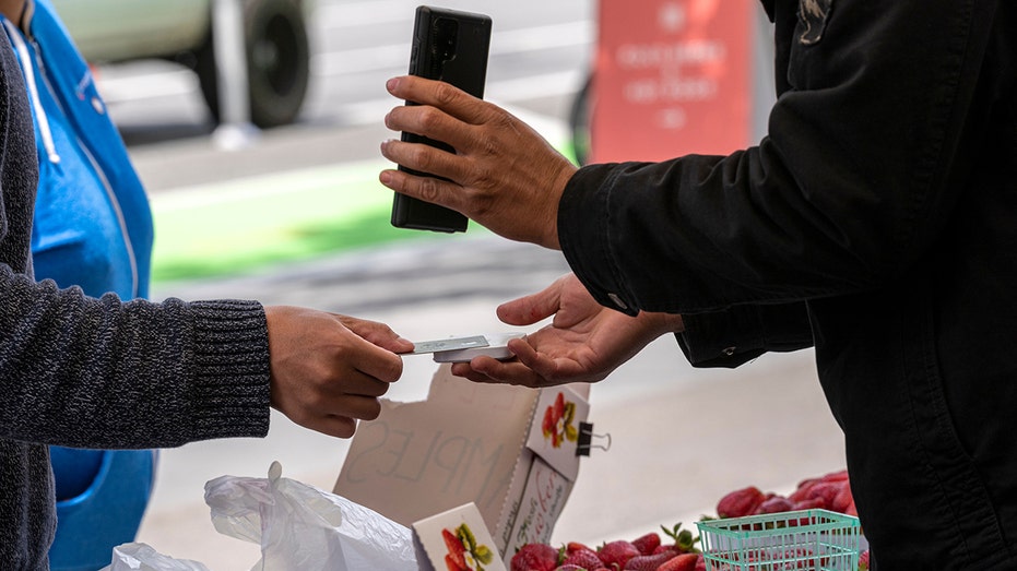 Buying produce at farmers market