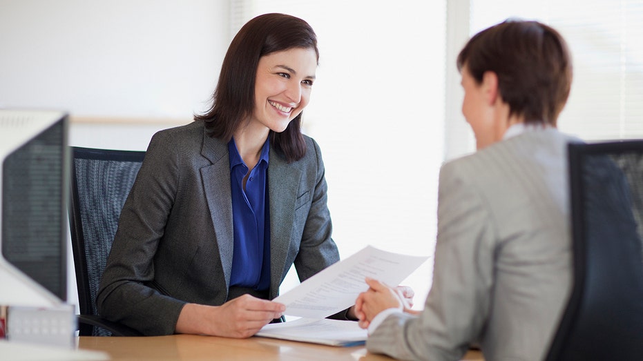 Two business professionals speaking in an office