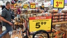 People shop in a grocery store as prices are displayed on October 12, 2023 in Los Angeles, California. The Consumer Price Index rose 3.7 percent in September, the same as it had in August and slightly higher than the 3.6 percent rate predicted by economists.  