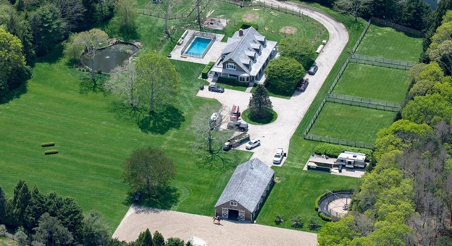 Aerial view of a stately home on a lush green property