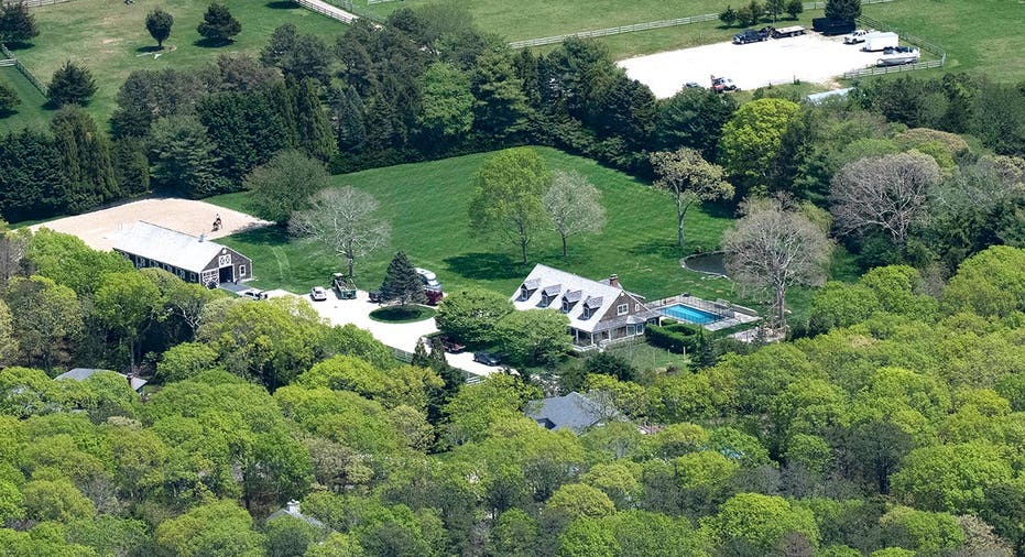 Aerial view of a stately home on a lush green property