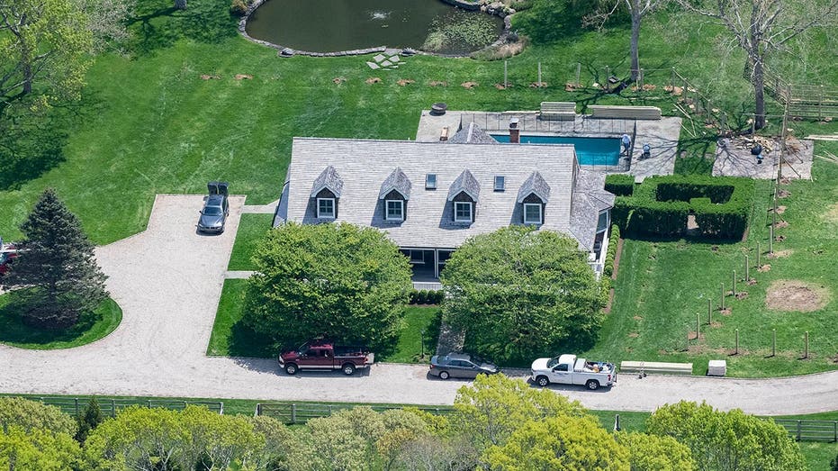 Aerial view of a stately home on a lush green property