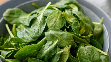 Baby spinach in stoneware plates and fabric on a wooden background. (Photo by: Eddy Buttarelli/REDA&amp;CO/Universal Images Group via Getty Images)