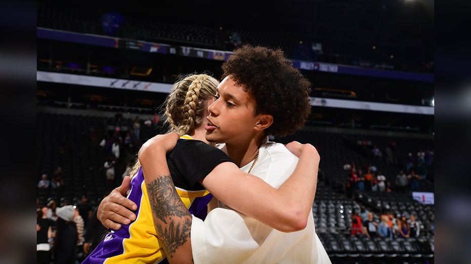 Brittney Griner hugs Cameron Brink after a game