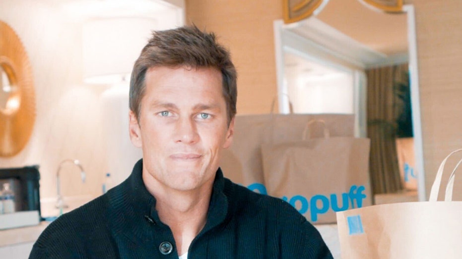 Tom Brady with GoPuff bag