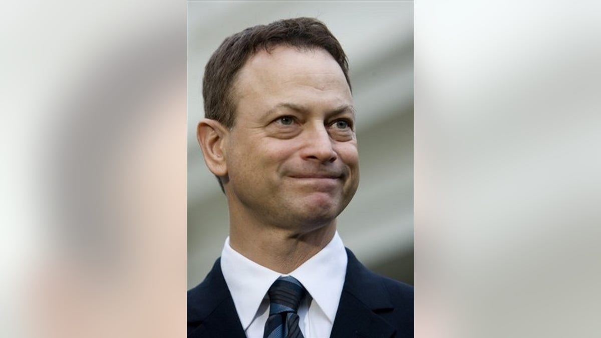 Actor Gary Sinise, a recipient of the 2008 Presidential Citizens Medal, speaks with members of the press, Wednesday, Dec. 10, 2008, outside the White House in Washington. (AP Photo/Haraz N. Ghanbari)