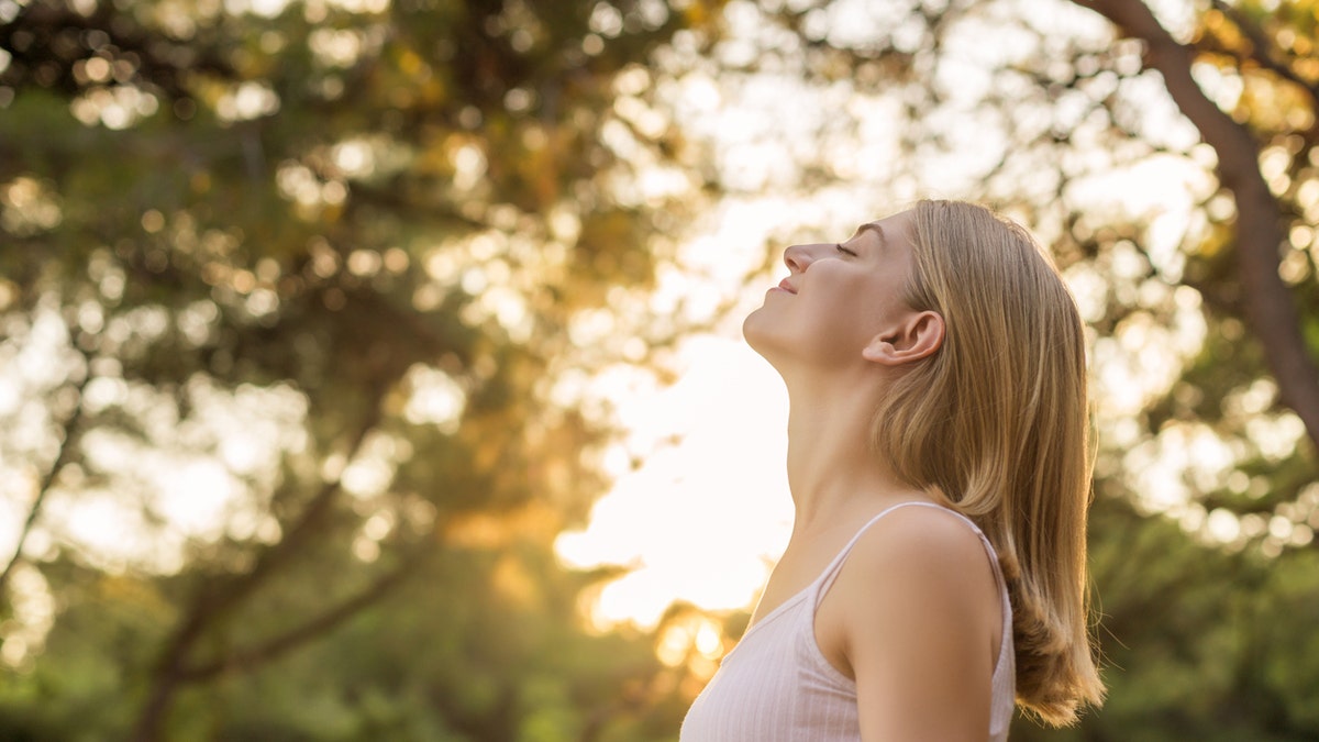 woman breathing outside