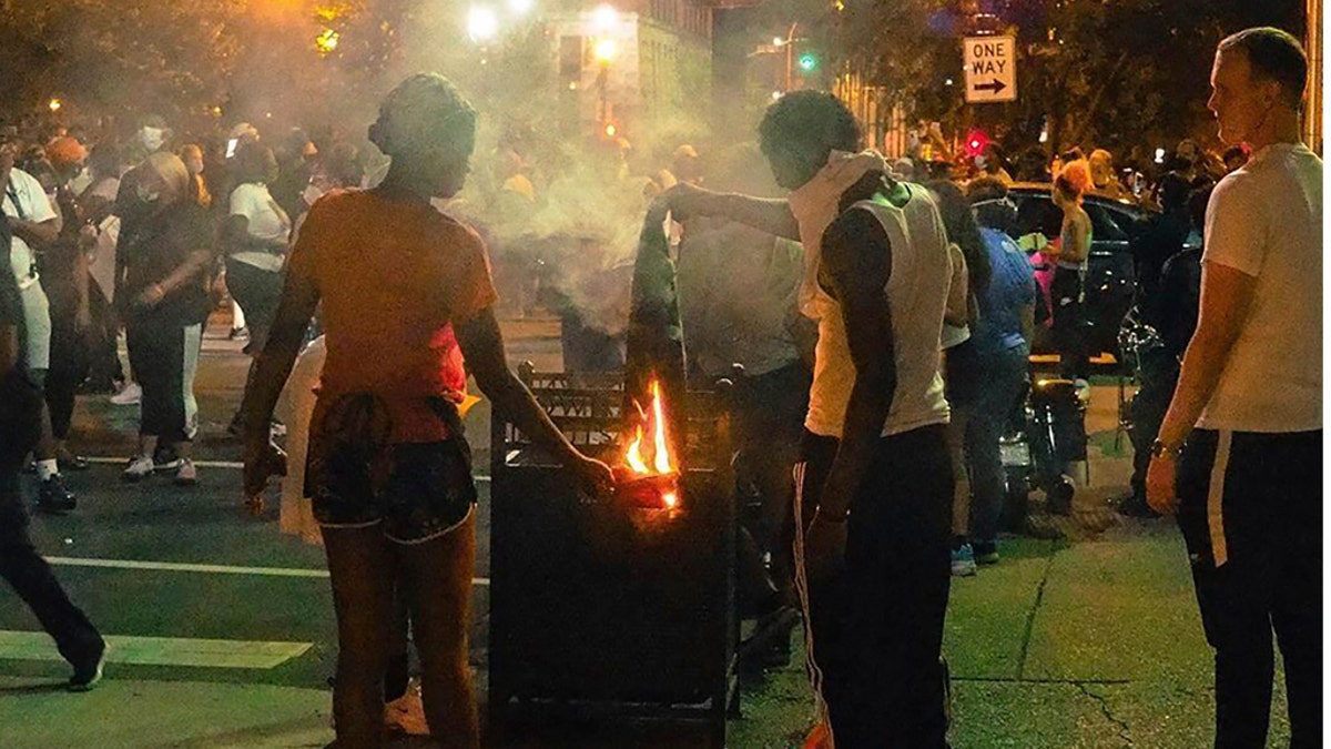 In this photo provided by instagram account of @mckinley_moore, demonstrators gather Thursday, May 28, 2020, in downtown Louisville, Ky., to protest the killing of Breonna Taylor, a black woman fatally shot by police in her home in March. (@mckinley_moore via AP)