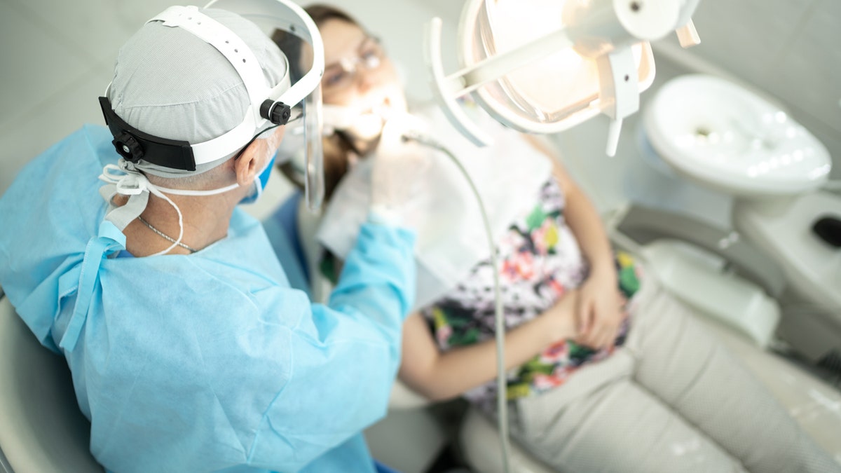 Dentist working on patient's teeth