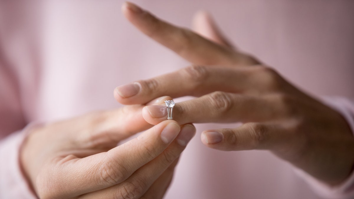 Photo of person taking ring off