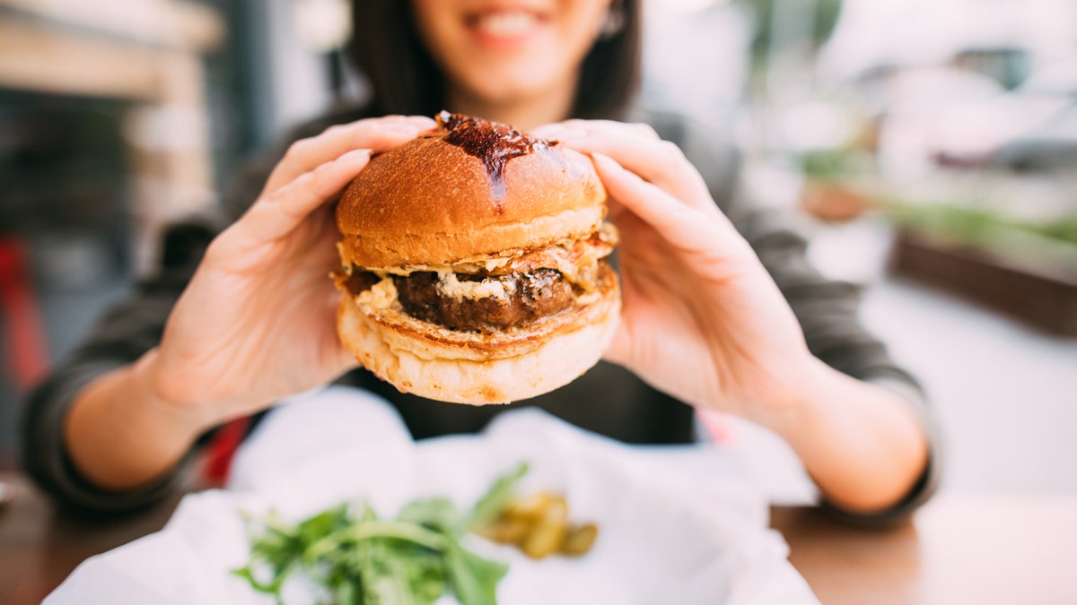 Woman eating beef burger