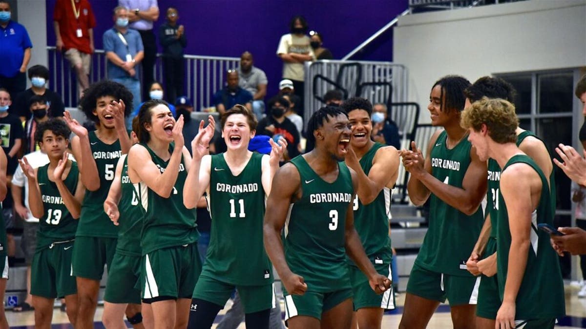 Coronado Islanders Varsity Basketball team celebrates their CIF Championship on the court after buzzer goes off in their 51-48 win over Orange Glen Friday, June 11, 2021 in San Diego. (Photo by Joan C . Fahrenthold).