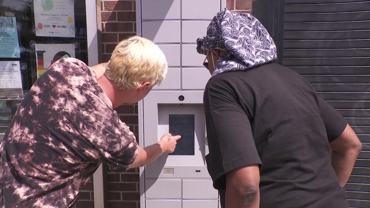 Philadelphia Department of Public Health worker with Narcan vending machine