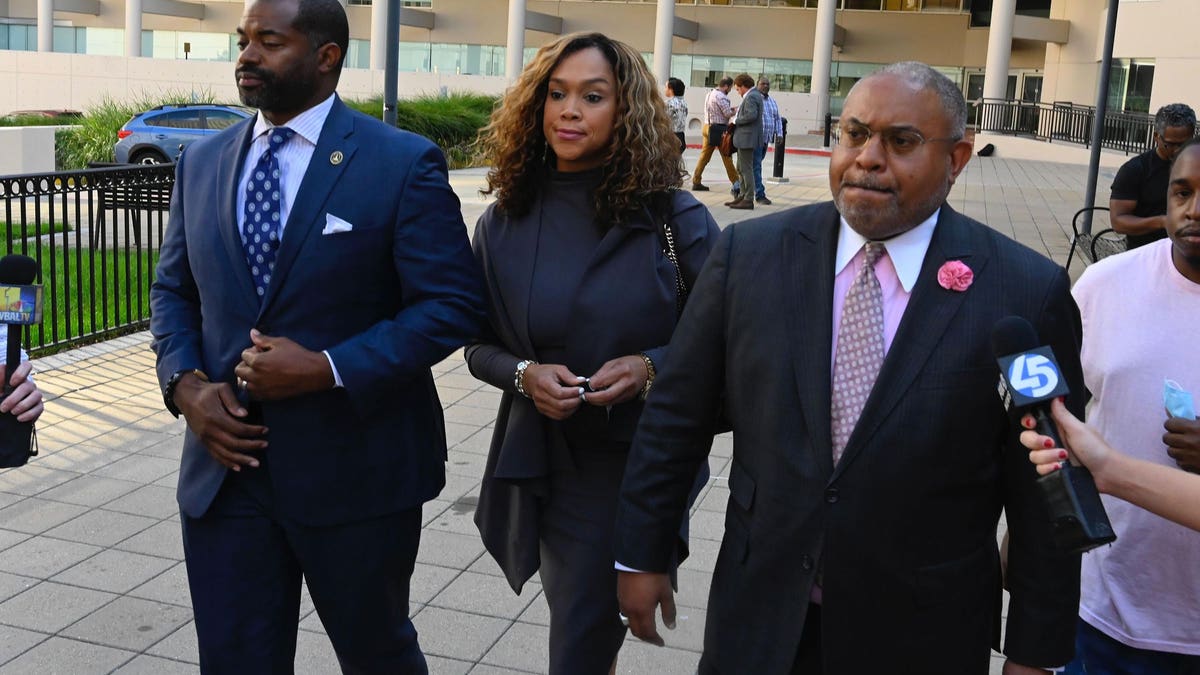 Marilyn Mosby walking with her lawyer