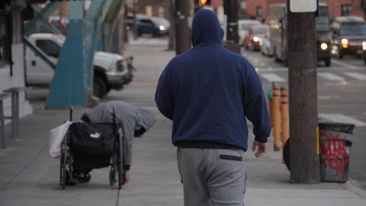 Addict's wheelchair faces street